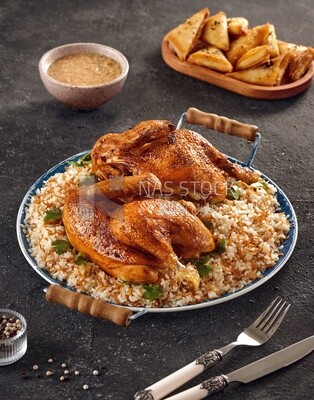 Side view of a dining table with chicken rice, samosa and soup