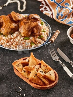 Side view of a dining table with samosa and chicken rice
