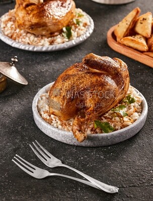 Side view of a dining table with chicken rice and samosa
