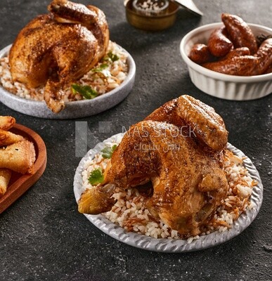 Side view of a dining table with chicken rice, samosa and mombar