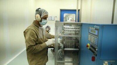 Two men in a medicine factory from inside
