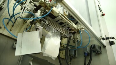Stage of pressing and closing bags of artificial baby milk and bags of vitamin powder