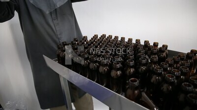 Specialist unloads a new set of empty medicine bottles to sterilize them and fill the medicine inside