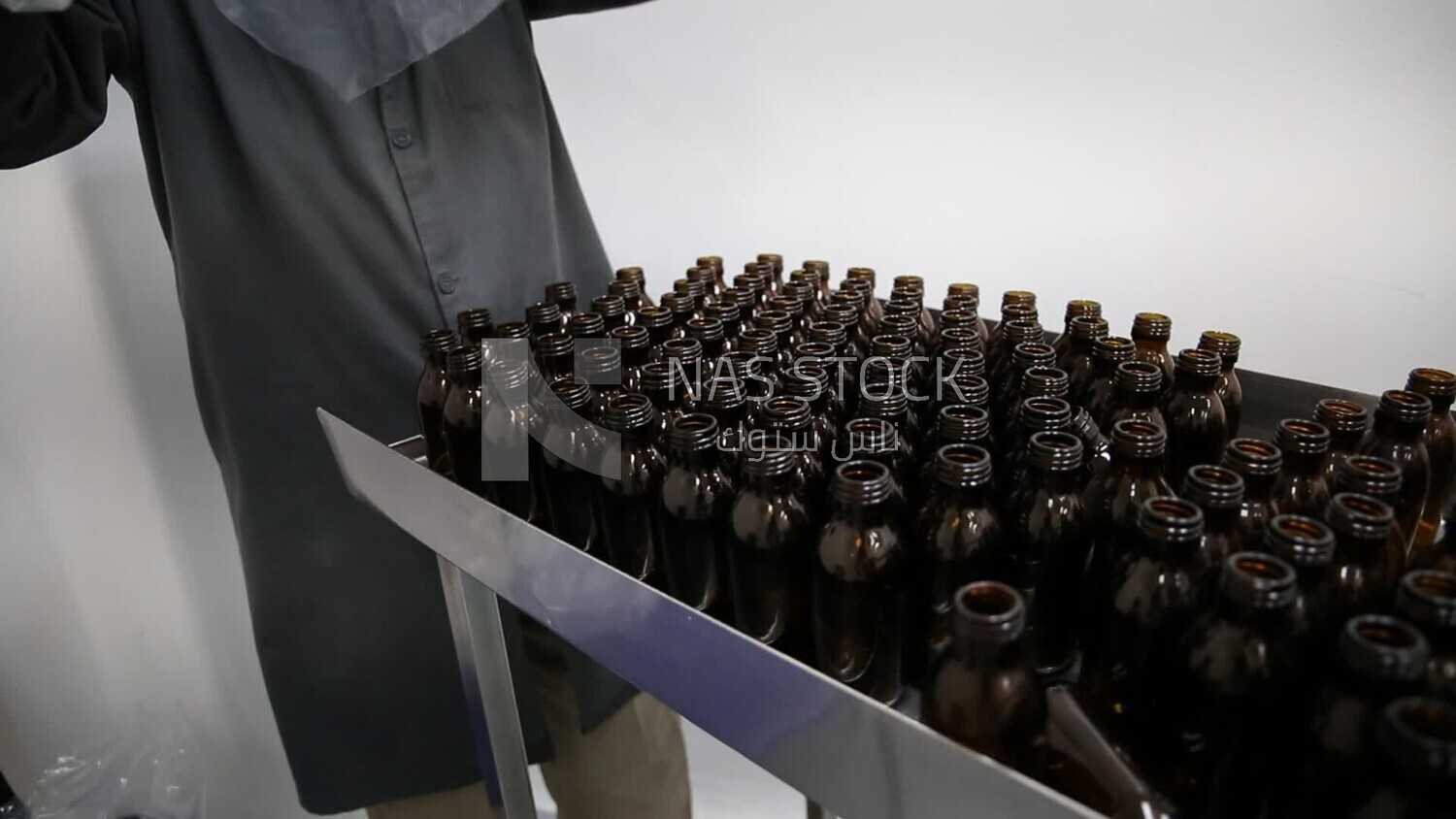 Specialist unloads a new set of empty medicine bottles to sterilize them and fill the medicine inside