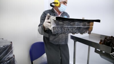 Specialist opens a new set of bottles to be used in packing medicines