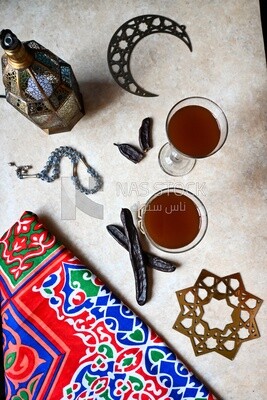 Two cups of carob with carob sticks, cold drinks, delicious natural juices, healthy and useful juice