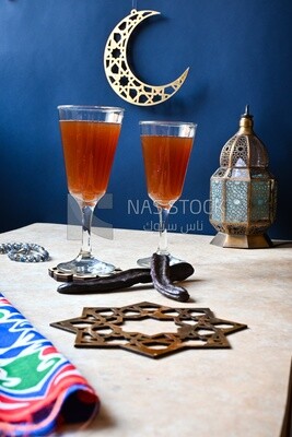 Two cups of carob with carob sticks, cold drinks, delicious natural juices, healthy and useful juice