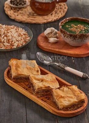 Plate of Molokhia, white rice, and crispy Phyllo Meat Pie (Egyptian goulash), traditional Arabic dishes, Arabic food, popular dishes, delicious recipes and dishes, delicious food