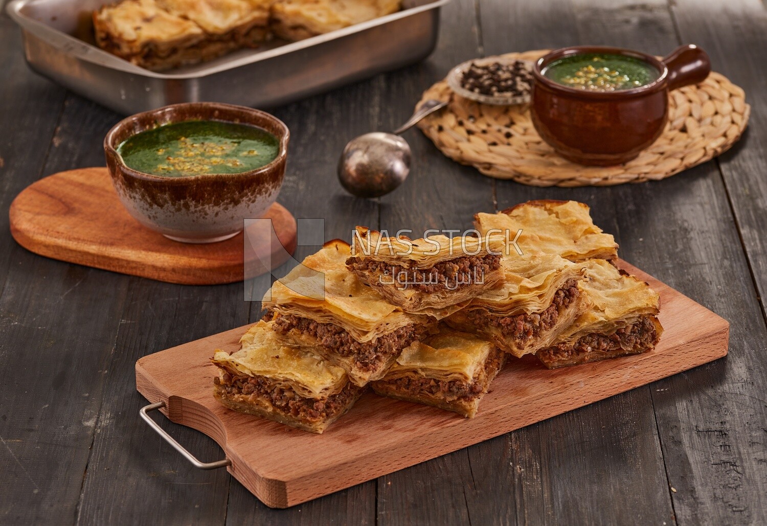 plate of Molokhia and crispy Phyllo Meat Pie (Egyptian goulash), traditional Arabic dishes, Arabic food, popular dishes, delicious recipes and dishes, delicious food