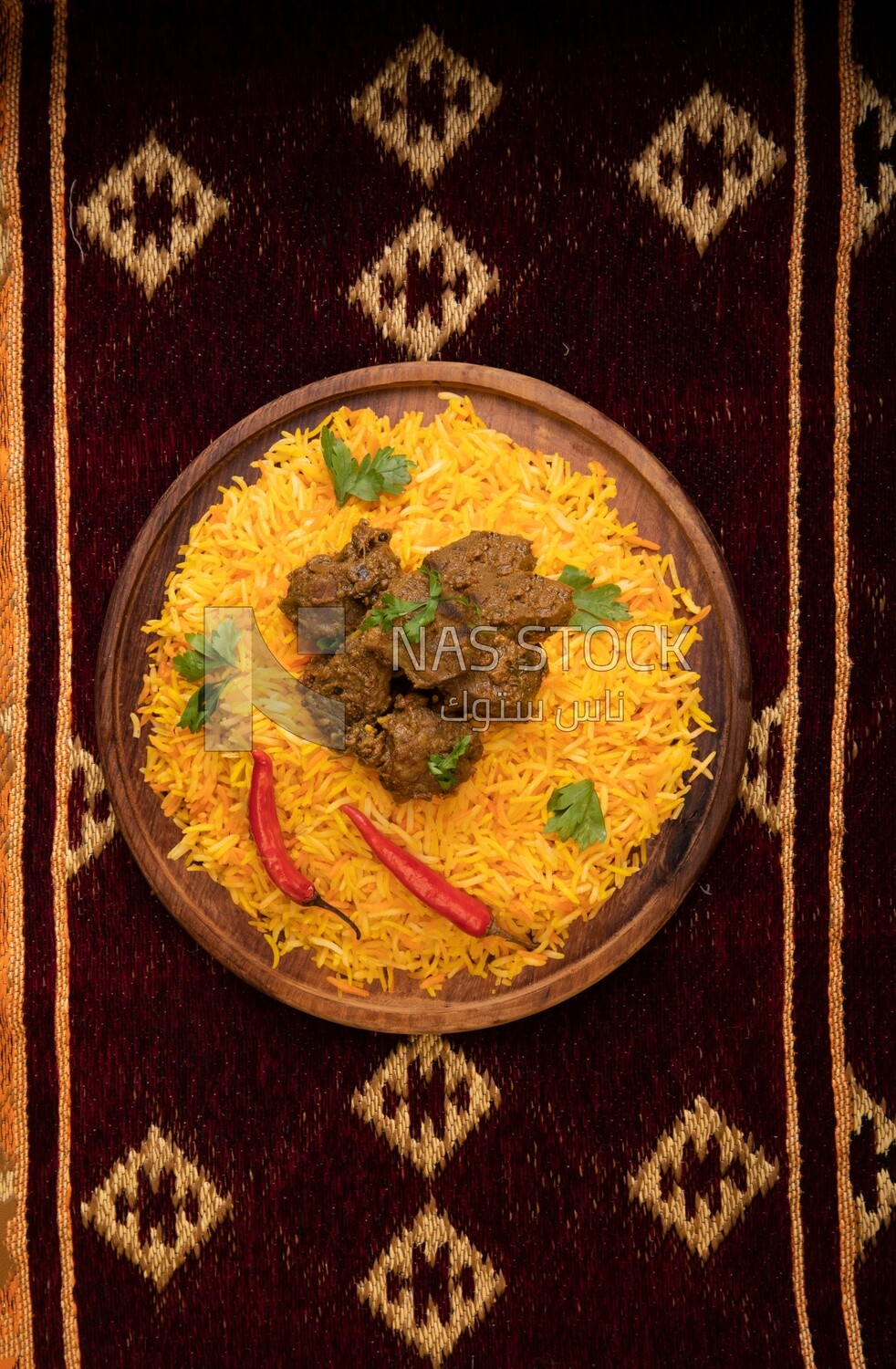 Wooden plate of delicious biryani rice with meat,  traditional Arabic dishes, Arabic food, popular dishes, delicious recipes and dishes, delicious food