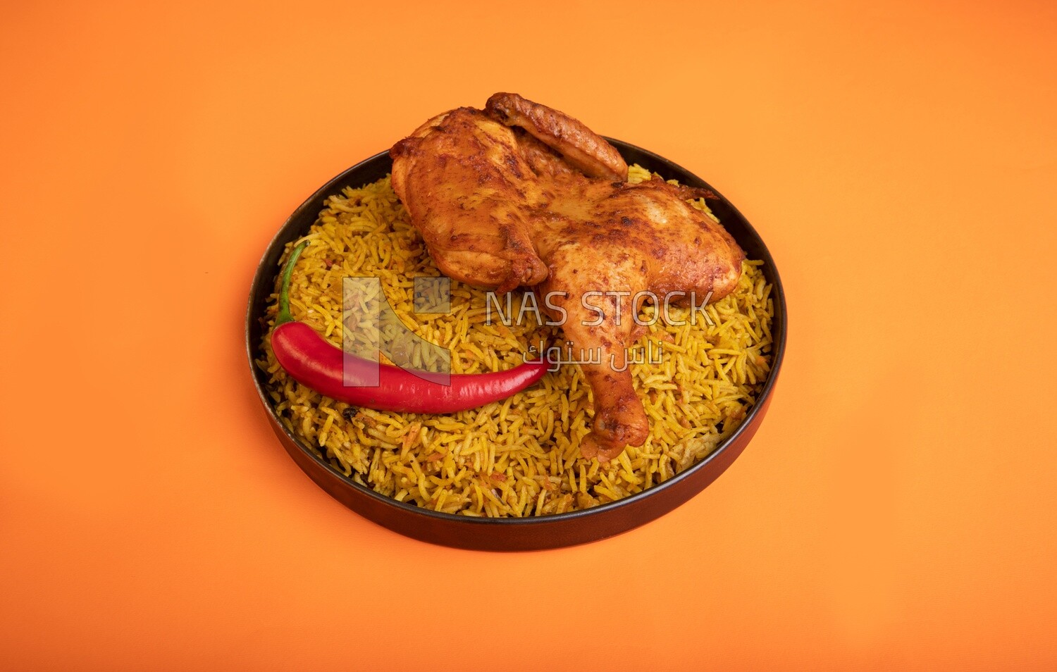 Plate of kabsa rice with chicken, traditional Saudi food, Saudi restaurant, Saudi dishes
