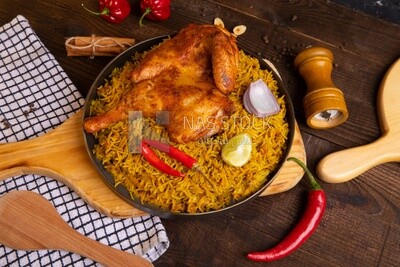 Plate of kabsa rice with chicken from the top, traditional Saudi food, Saudi restaurant, Saudi dishes