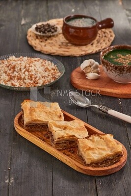 Plate of Molokhia, white rice, and crispy Phyllo Meat Pie (Egyptian goulash), traditional Arabic dishes, Arabic food, popular dishes, delicious recipes and dishes, delicious food