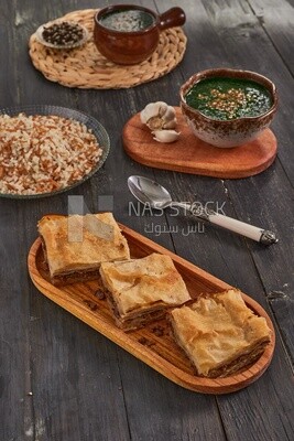 Plate of Molokhia, white rice, and crispy Phyllo Meat Pie (Egyptian goulash), traditional Arabic dishes, Arabic food, popular dishes, delicious recipes and dishes, delicious food