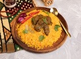 Wooden plate of delicious biryani rice with meat and a plate of dates,  traditional Arabic dishes, Arabic food, popular dishes, delicious recipes and dishes, delicious food