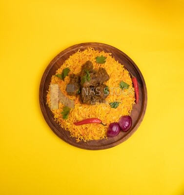 Wooden plate of delicious biryani rice with meat,  traditional Arabic dishes, Arabic food, popular dishes, delicious recipes and dishes, delicious food