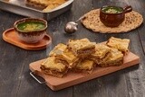 Plate of Molokhia and crispy Phyllo Meat Pie (Egyptian goulash), traditional Arabic dishes, Arabic food, popular dishes, delicious recipes and dishes, delicious food