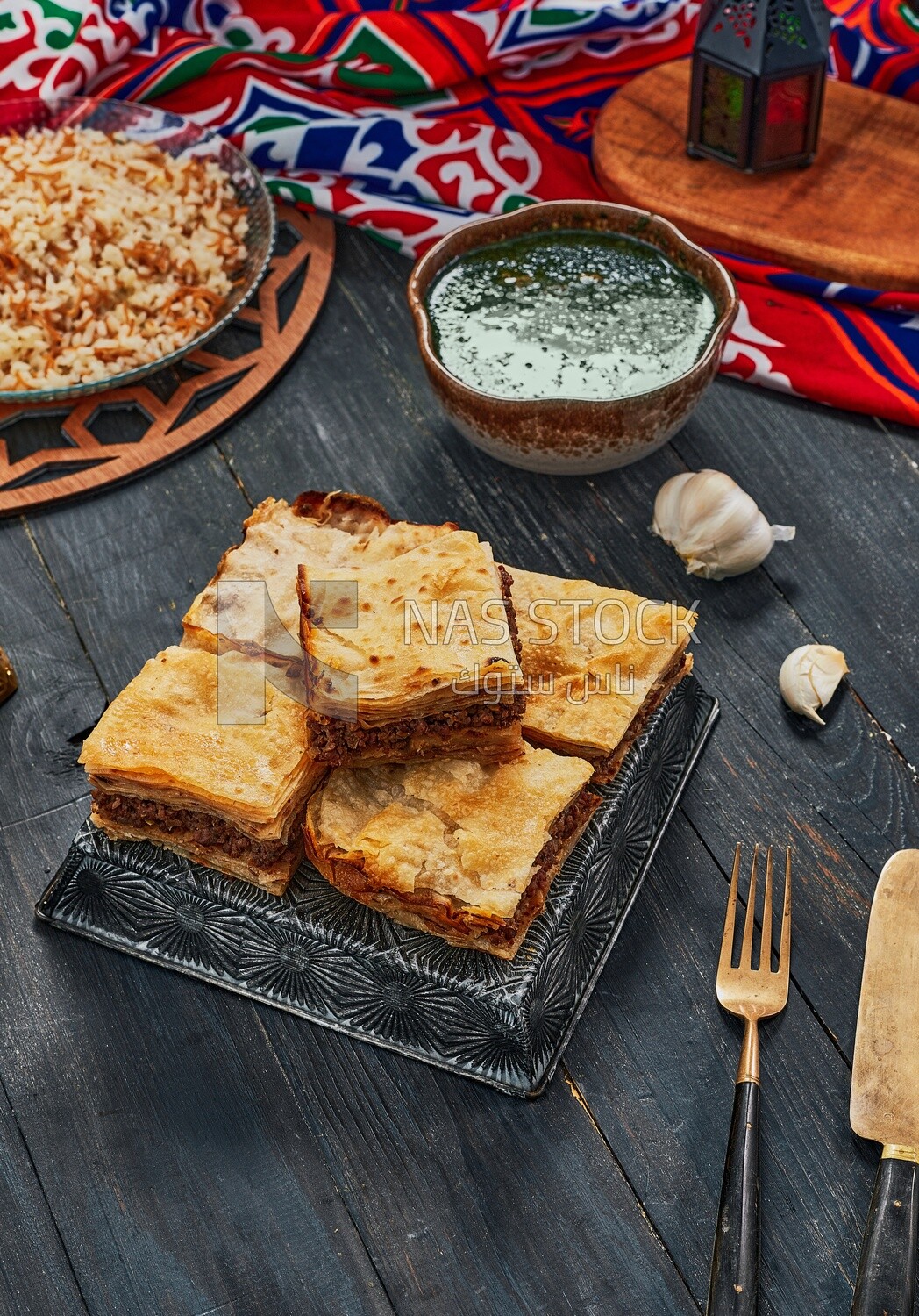 Plate of Molokhia, white rice, and crispy Phyllo Meat Pie (Egyptian goulash), traditional Arabic dishes, Arabic food, popular dishes, delicious recipes and dishes, delicious food