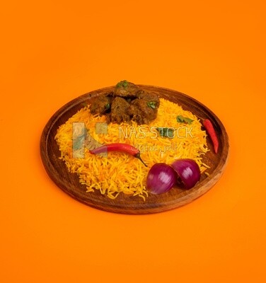 Wooden plate of delicious biryani rice with meat, traditional Arabic dishes, Arabic food, popular dishes, delicious recipes and dishes, delicious food