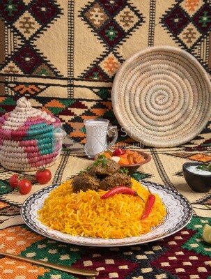 Wooden plate of delicious biryani rice with meat and a plate of dates,  traditional Arabic dishes, Arabic food, popular dishes, delicious recipes and dishes, delicious food