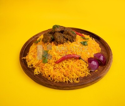 Wooden plate of delicious biryani rice with meat,  traditional Arabic dishes, Arabic food, popular dishes, delicious recipes and dishes, delicious food