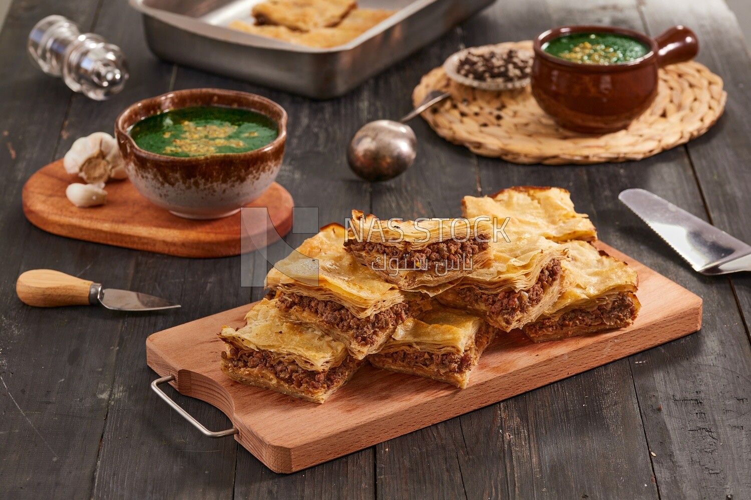 Plate of Molokhia and crispy Phyllo Meat Pie (Egyptian goulash), traditional Arabic dishes, Arabic food, popular dishes, delicious recipes and dishes, delicious food