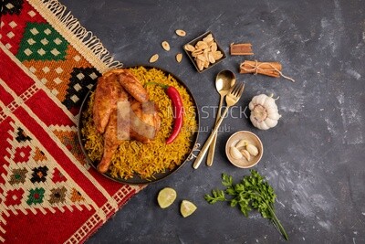 Plate of kabsa rice with chicken from the top, traditional Saudi food, Saudi restaurant, Saudi dishes