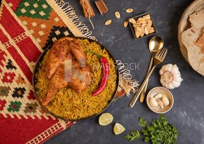 Plate of kabsa rice with chicken from the top, traditional Saudi food, Saudi restaurant, Saudi dishes