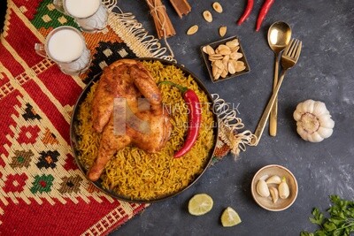 Plate of kabsa rice with chicken from the top, traditional Saudi food, Saudi restaurant, Saudi dishes