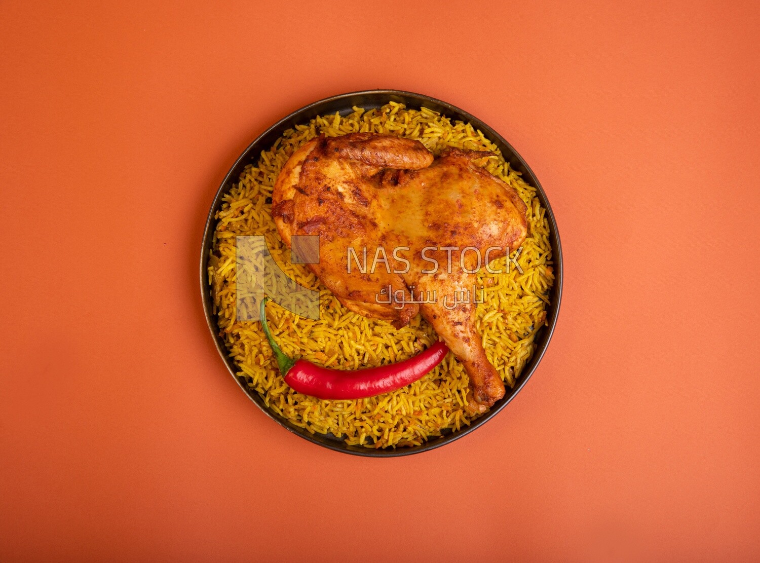 Plate of kabsa rice with chicken from the top, traditional Saudi food, Saudi restaurant, Saudi dishes