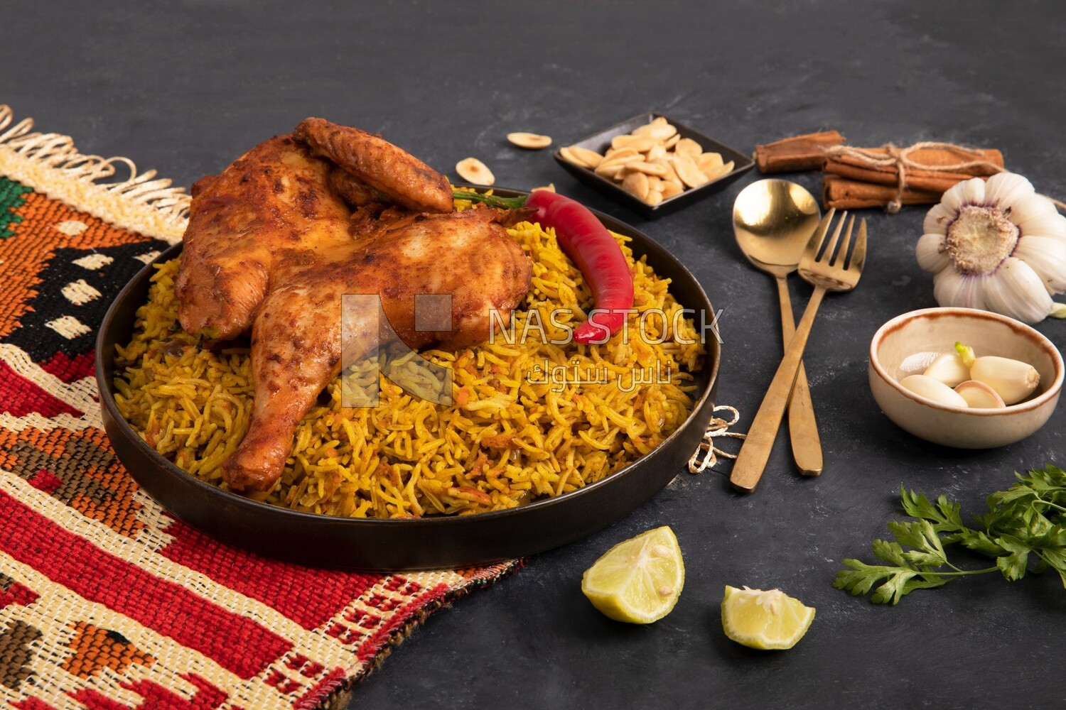 Plate of kabsa rice with chicken and cinnamon sticks, traditional Saudi food, Saudi restaurant, Saudi dishes