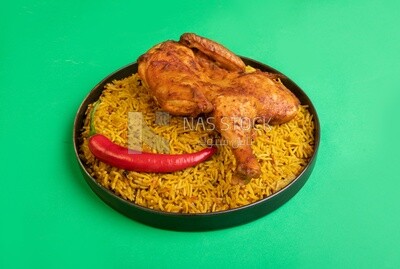 Plate of kabsa rice with chicken, traditional Saudi food, Saudi restaurant, Saudi dishes