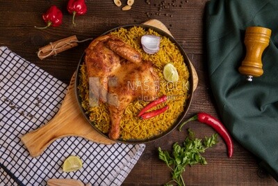 Plate of kabsa rice with chicken from the top, traditional Saudi food, Saudi restaurant, Saudi dishes