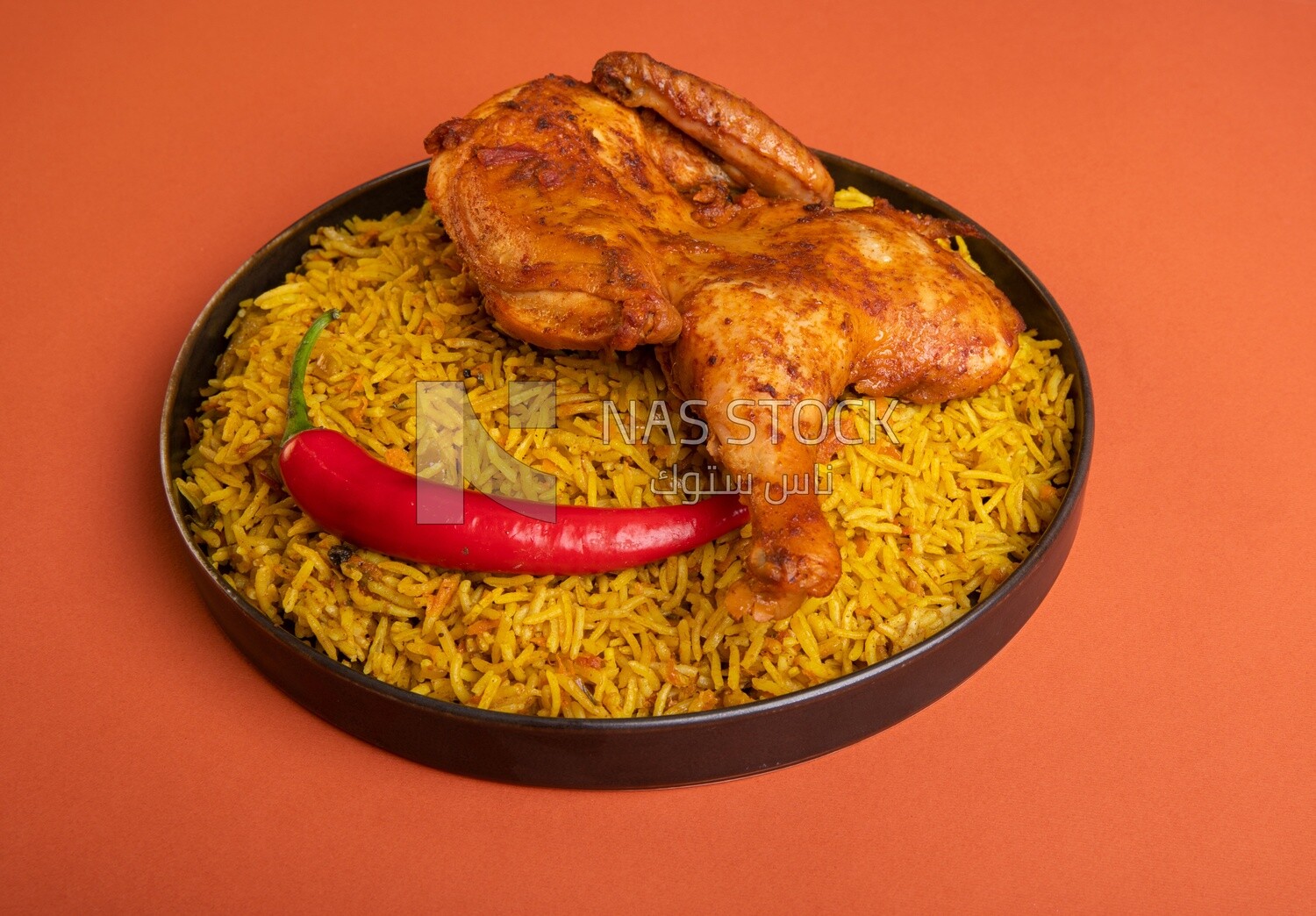 Plate of kabsa rice with chicken, traditional Saudi food, Saudi restaurant, Saudi dishes