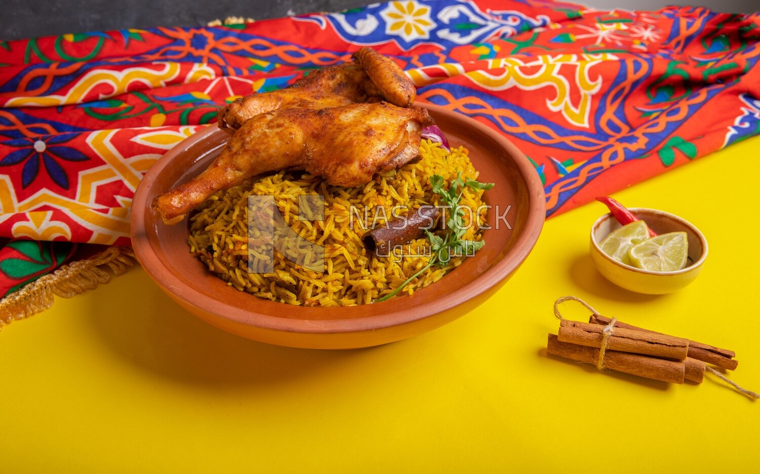Plate of kabsa rice with chicken and cinnamon sticks, traditional Saudi food, Saudi restaurant, Saudi dishes