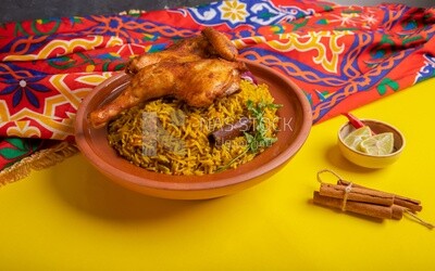Plate of kabsa rice with chicken and cinnamon sticks, traditional Saudi food, Saudi restaurant, Saudi dishes