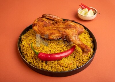 Plate of kabsa rice with chicken, traditional Saudi food, Saudi restaurant, Saudi dishes