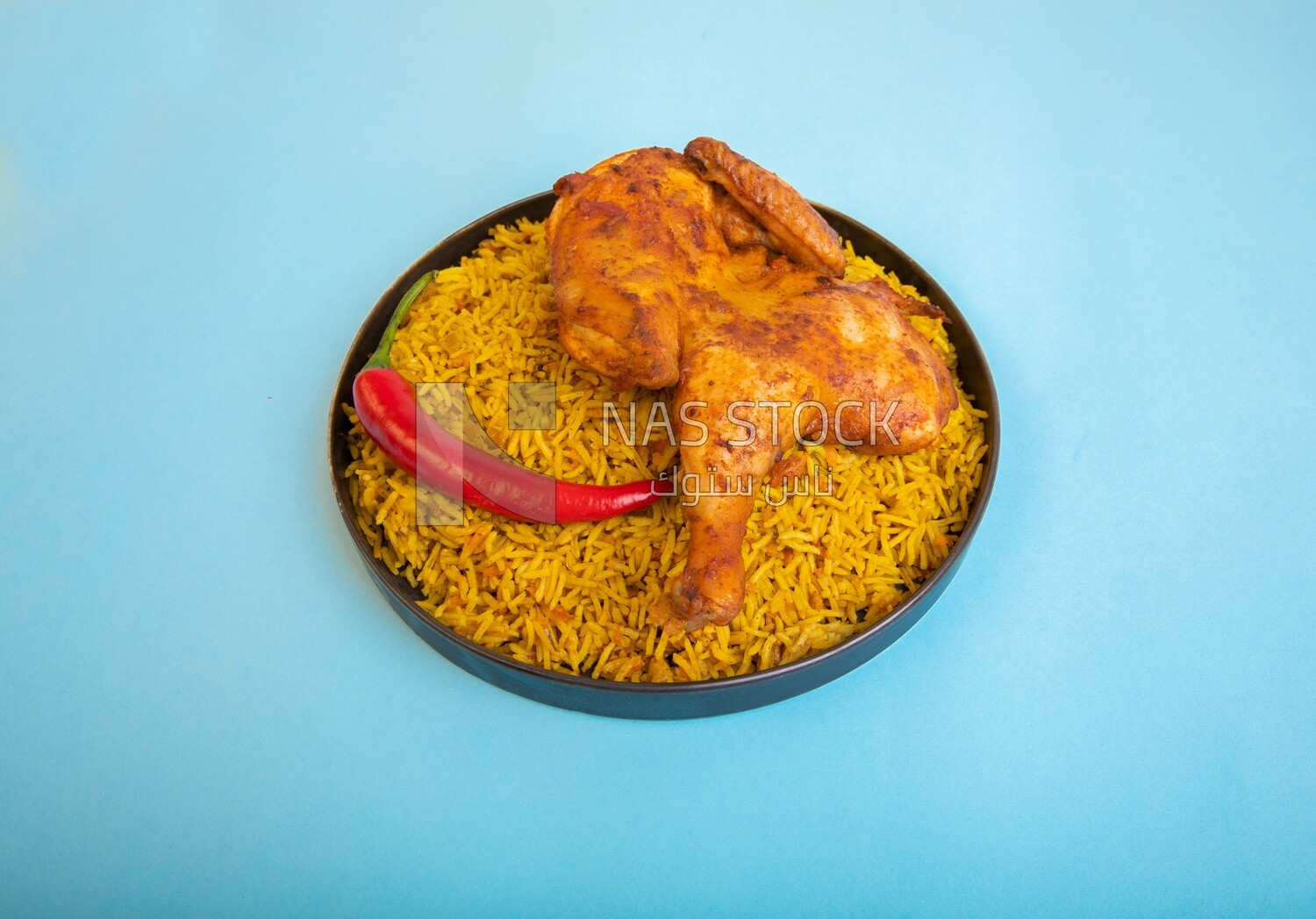 Plate of kabsa rice with chicken, traditional Saudi food, Saudi restaurant, Saudi dishes