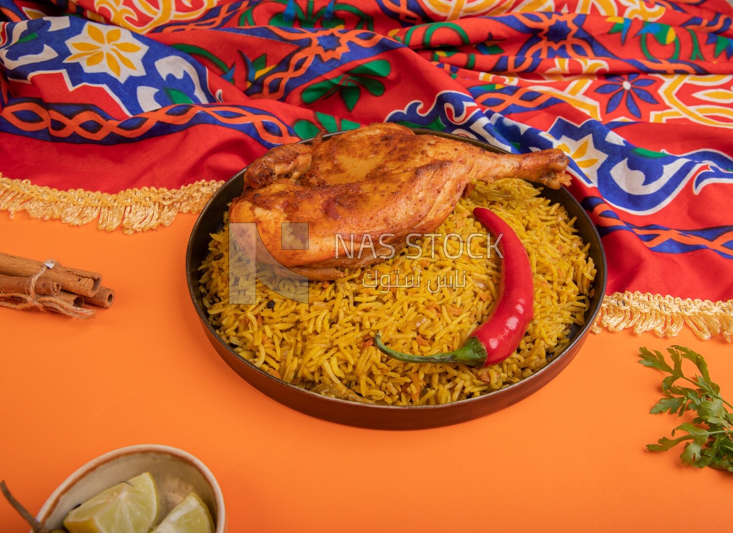 Plate of kabsa rice with chicken and cinnamon sticks, traditional Saudi food, Saudi restaurant, Saudi dishes