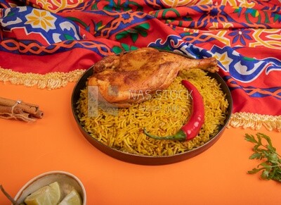 Plate of kabsa rice with chicken and cinnamon sticks, traditional Saudi food, Saudi restaurant, Saudi dishes