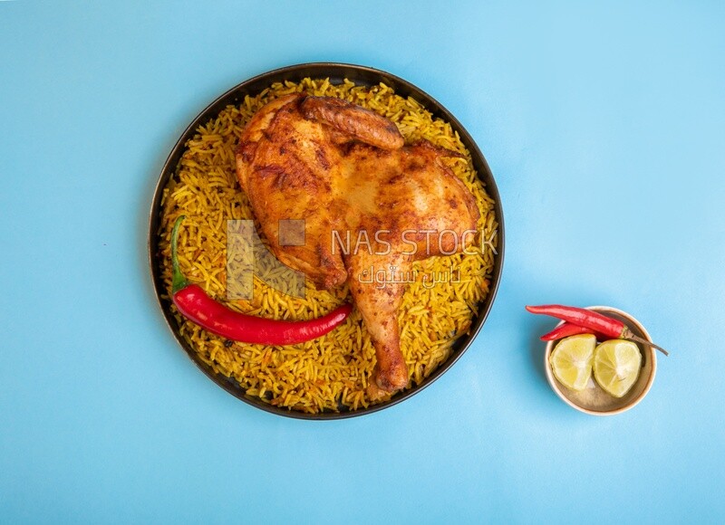 Plate of kabsa rice with chicken from the top, traditional Saudi food, Saudi restaurant, Saudi dishes