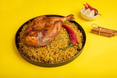 Plate of kabsa rice with chicken and cinnamon sticks, traditional Saudi food, Saudi restaurant, Saudi dishes