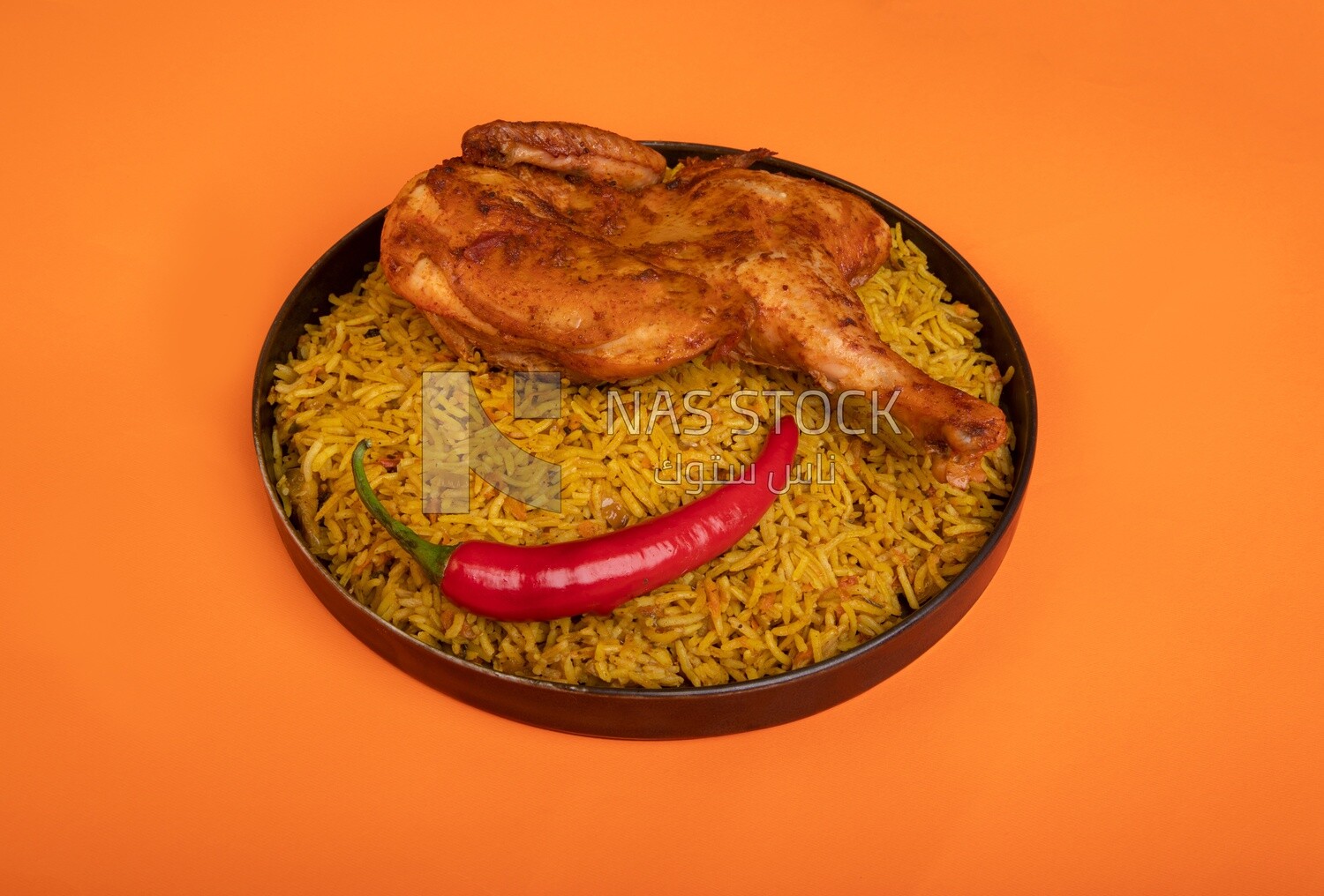 Plate of kabsa rice with chicken, traditional Saudi food, Saudi restaurant, Saudi dishes