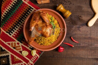 Plate of kabsa rice with chicken from the top, traditional Saudi food, Saudi restaurant, Saudi dishes