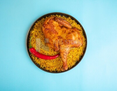 Plate of kabsa rice with chicken from the top, traditional Saudi food, Saudi restaurant, Saudi dishes