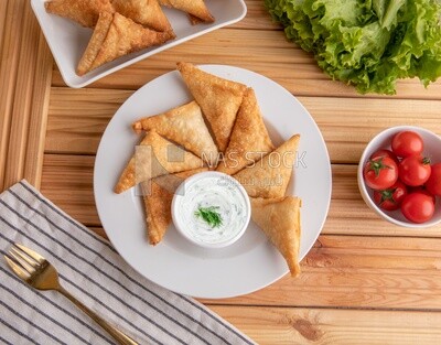 Plate of samosa with yogurt salad, popular dishes, appetizers, Arabic dishes, oriental dishes, restaurants for oriental Arabic food, delicious meals