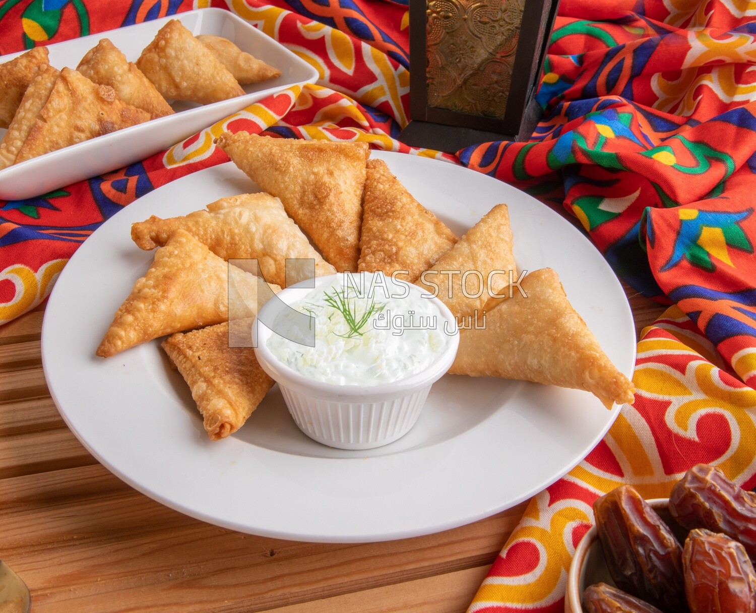 Plate of samosa with yogurt salad, popular dishes, appetizers, Arabic dishes, oriental dishes, restaurants for oriental Arabic food, delicious meals