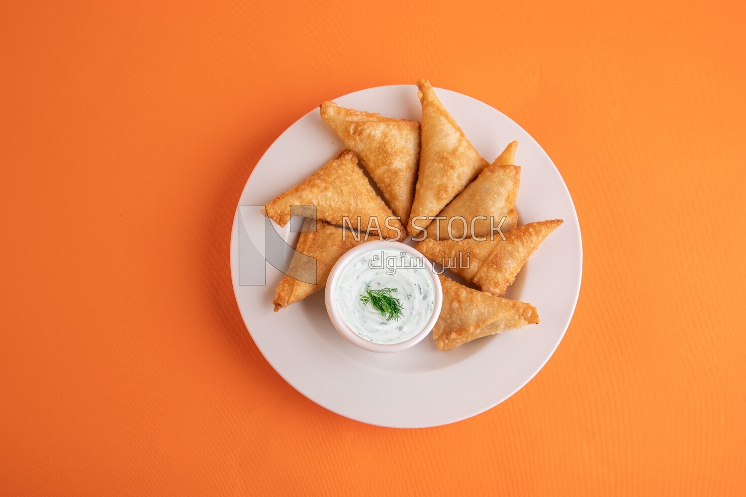 Plate of samosa with yogurt salad, popular dishes, appetizers, Arabic dishes, oriental dishes, restaurants for oriental Arabic food, delicious meals