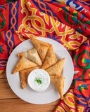 Plate of samosa with yogurt salad, popular dishes, appetizers, Arabic dishes, oriental dishes, restaurants for oriental Arabic food, delicious meals