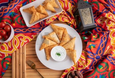 Plate of samosa with yogurt salad, popular dishes, appetizers, Arabic dishes, oriental dishes, restaurants for oriental Arabic food, delicious meals